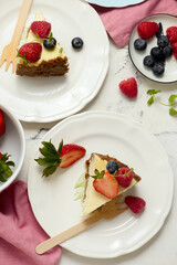 Pieces of cheesecake with berries on plates.top veiw..style hugge