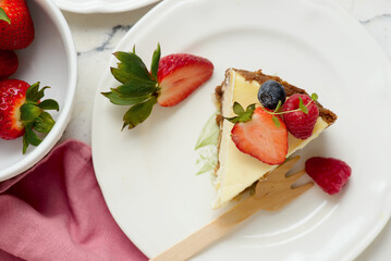 Pieces of cheesecake with berries on plates.top veiw..style hugge