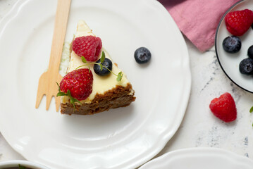 Pieces of cheesecake with berries on plates.top veiw..style hugge