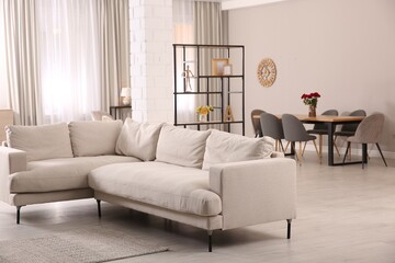 Modern living room interior with comfortable sofa and wooden table