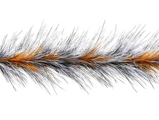 Close-up of a textured brush-like object with a blend of white black and orange bristles or fibers on a white background.