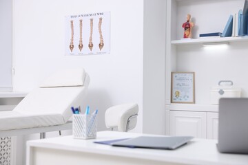Laptop and folders on desk in medical office, closeup
