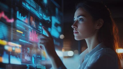 A focused businesswoman uses hand gestures to manipulate a holographic touchscreen interface displaying interactive data analytics. The scene highlights her concentration as colorful