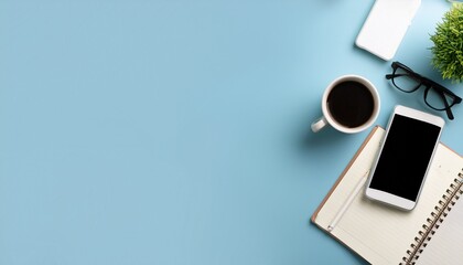 A mockup photo of a working desk viewed from the top is displayed on a pastel blue backgroun