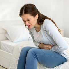Obraz premium young woman sitting on sofa hand in her back for extreme pain