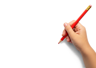 child's hand writing with red pencil