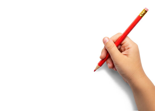child's hand writing with red pencil
