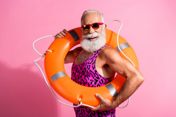 Photo of lifeguard old man wearing leopard print swimsuit orange rescue ring isolated pastel color background