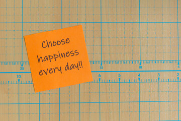 Colored paper note with adhesive tape with motivational phrases, post it glued on a very nice wooden board, copy space