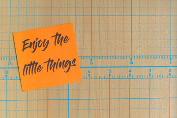 Colored paper note with adhesive tape with motivational phrases, post it glued on a very nice wooden board, copy space