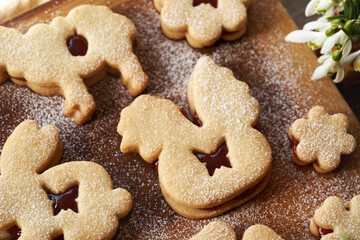 Linzer cookies in the shape of Easter animals filled with strawberry marmalade and dusted with sugar