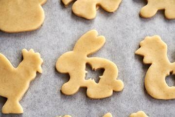 Linzer cookies in the shape of Easter animals cut out from raw pastry dough