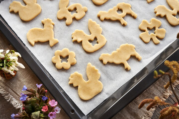 Linzer cookies in the shape of Easter animals cut out from raw pastry dough