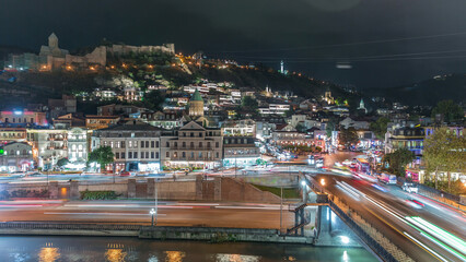 Fototapeta premium Colorful traditional houses with wooden carved balconies in the Old Town of Tbilisi aerial timelapse, Georgia.