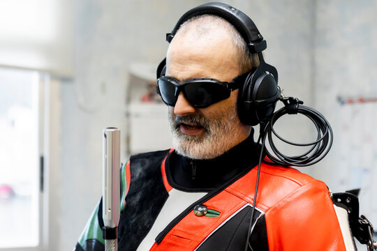 Blind marksman in professional gear focuses during training