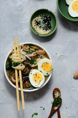 Ramen soup with chicken, shiitake mushrooms, spinach and egg in bowls .style hugge