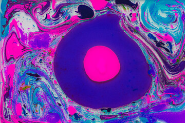 Vivid abstract art with swirling colors and central pink disc