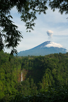 Scenic view of Kaspa Biru Waterfall with active volcano and distant waterfall