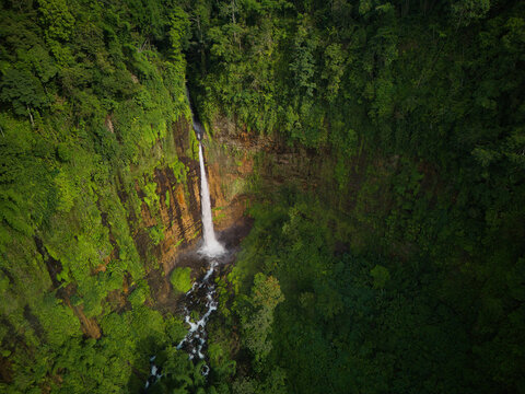 Aerial view of Kaspa Biru Waterfall surrounded by lush greenery