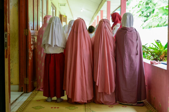 Back view of unrecognizable women in colorful traditional attire