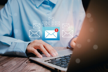 Person Typing on Laptop with Mail Notifications in a Bright, Modern Workspace Setting, Business concept
