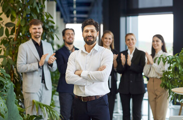 Portrait of a young happy smiling confident bearded business man in formal clothes looking cheerful...