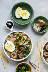 Ramen soup with chicken, shiitake mushrooms, spinach and egg in bowls .style hugge