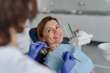 A woman has a check-up in dental clinic.