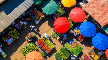 Aerial view of a vibrant market with colorful umbrellas and fresh produce stalls bustling with activity