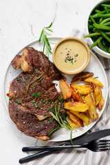 steak with  sauce and potatoes.