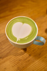 Experience an Elegant Matcha Latte with a Beautiful Creamy Pattern in a Cozy and Inviting Setting