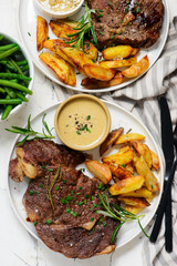 steak with  sauce and potatoes.