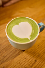 Experience an Elegant Matcha Latte with a Beautiful Creamy Pattern in a Cozy and Inviting Setting