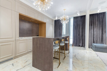 Spacious kitchen with built-in wardrobe, high table with bar stools. Beautiful curtains on the windows.