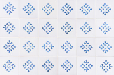 Traditional decorative tiles with blue floral motifs on a white background.