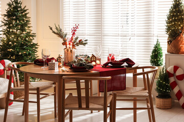 Christmas table setting with stylish dishware and festive decor indoors