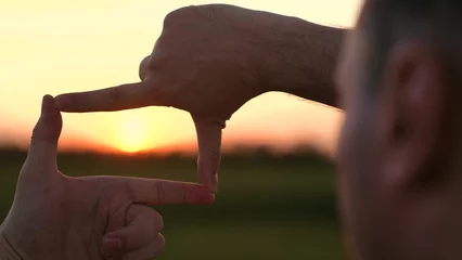 Fotobehang Chocoladebruin man stands serene field, capturing perfect sunset shot, capturing the perfect sunset, photographer perspective, golden hour magic, framing moment, chasing light, through lens, visual storytelling tips  © TO LOVE