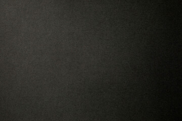 Black paper surface with grainy texture