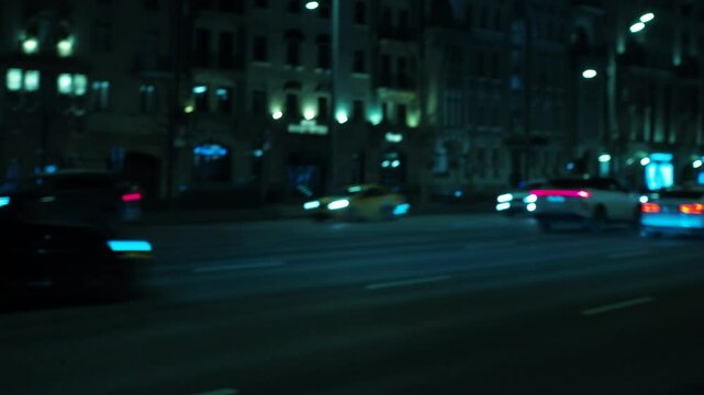 blurred background of nighttime traffic on a city highway, highlighted by the striking blue flashing lights of passing police cars. The smooth, out-of-focus effect creates a dynamic and atmospheric sc