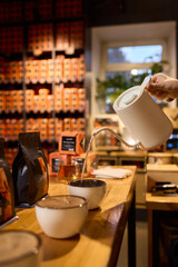 Pouring a Hot Beverage into Beautifully Crafted Stylish Cups for Everyone to Enjoy Together