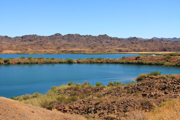 View of Lake Havasu and Colorado River near Lake Havasu City, Arizona, USA with view of California and blue sky copy space.