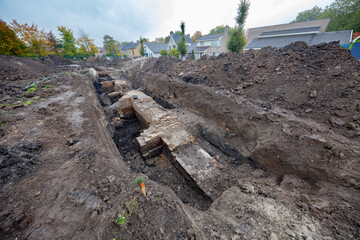 Excavation of ancient city walls reveals historical layers beneath urban landscape