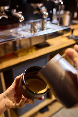 An Artisan Barista Skillfully Preparing a Beautiful Latte with an Intricate Milk Foam Design