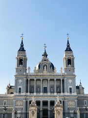 Obraz premium Cathedral with detailed facade and towers in Madrid, Spain under blue sky