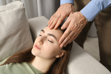 Psychologist working with patient during hypnosis session indoors, closeup