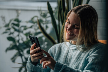 young woman 20s chatting with mobile phone