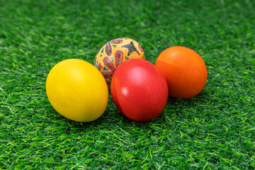 Colorful Painted Easter Eggs on Green Artificial Grass with Blue Background