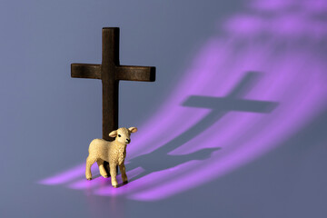 Lamb of God Standing Next to Wooden Christian Cross with Purple Church Window Shadow