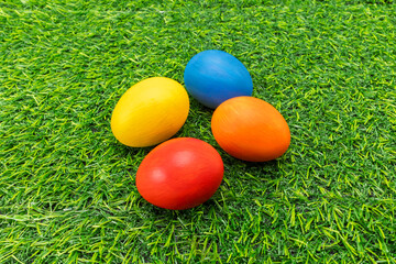 Colorful Hand Painted Easter Eggs on Green Artificial Grass