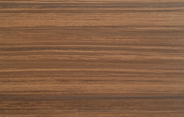 Naklejka premium A flat brown cardboard texture with a slightly worn look and visible paper grain, offering an authentic feel. The uniform background highlights the cardboard's texture, ideal for base layers and addin